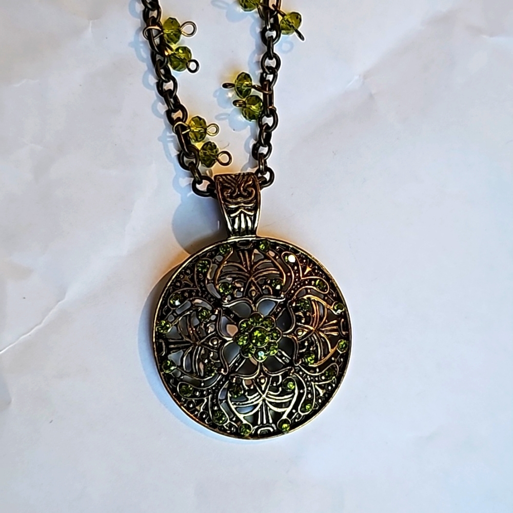 Gold tone and green crystal necklace